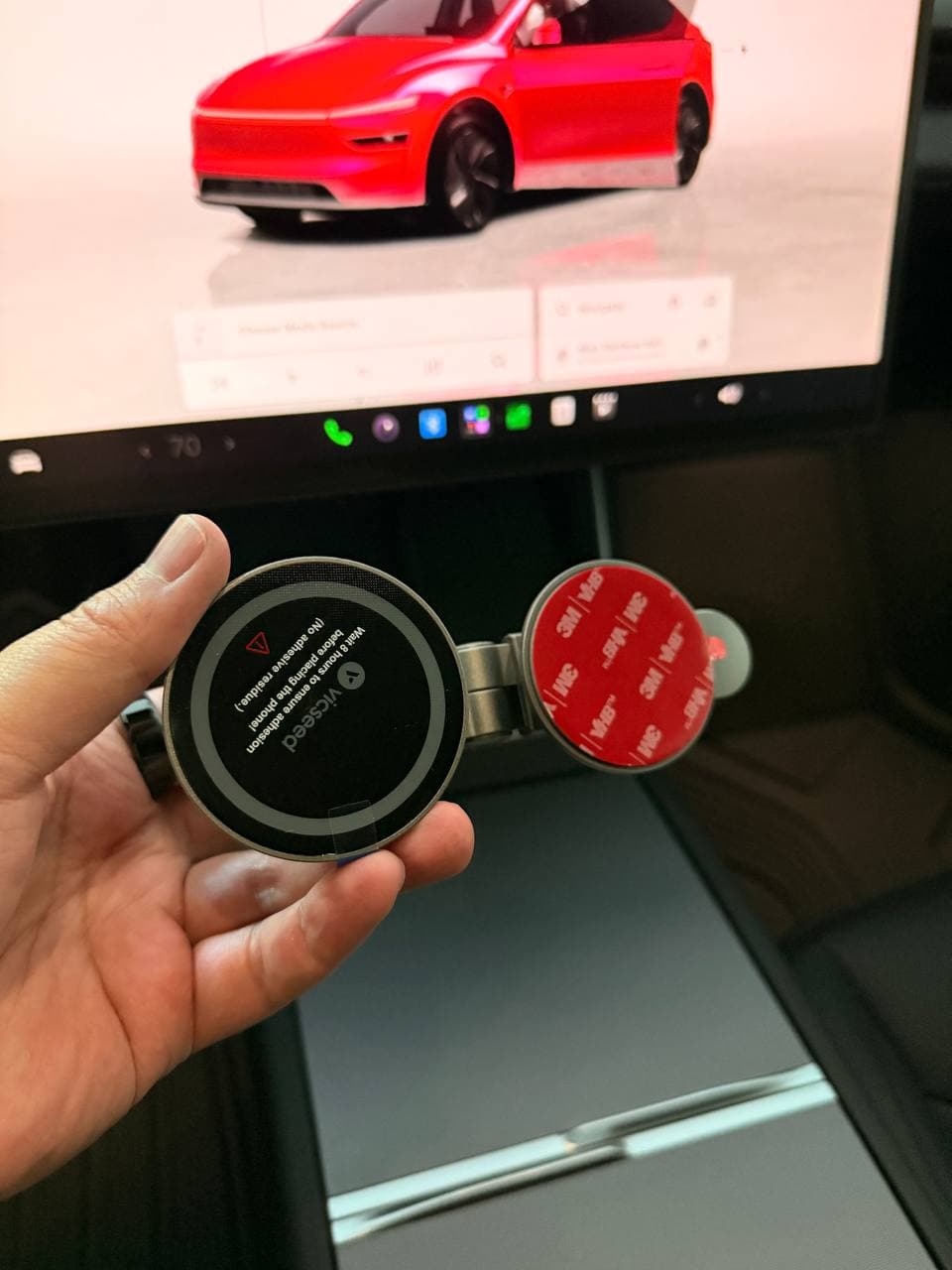 VICSEED phone mount being adjusted by hand in a Tesla interior