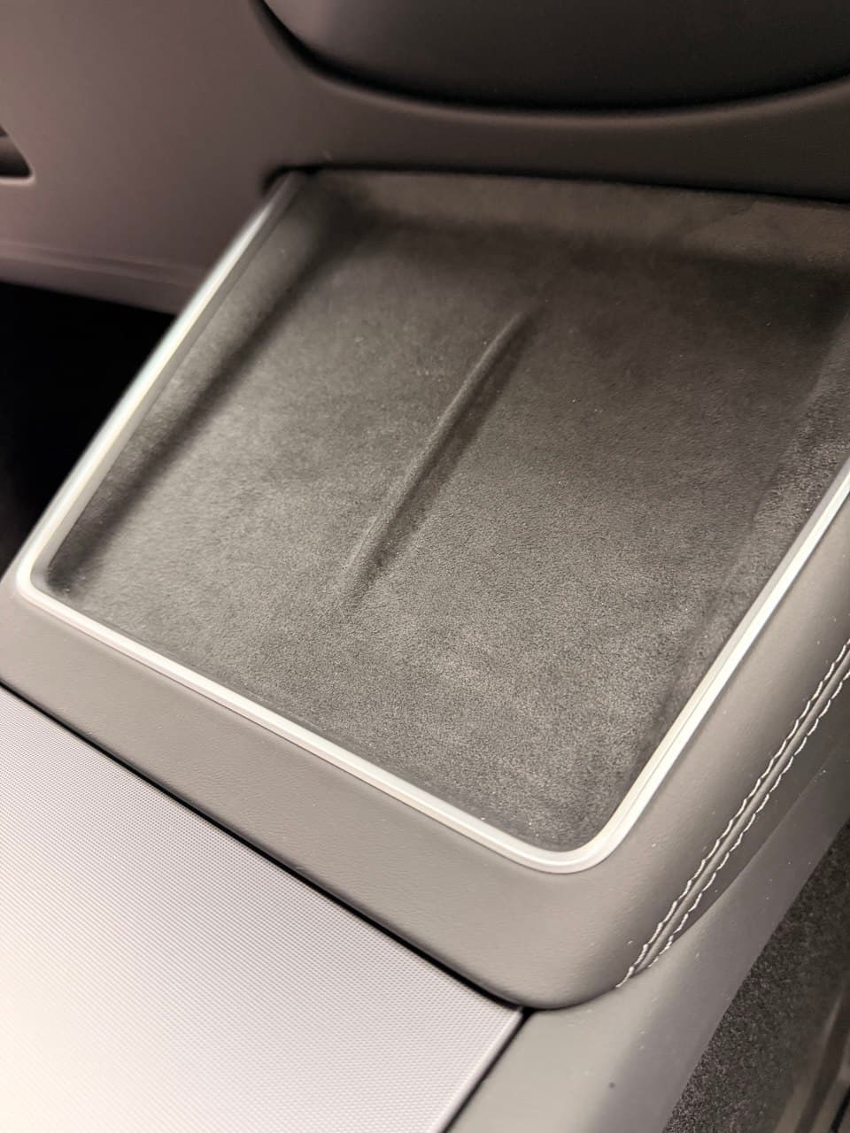 Wireless charging pad installed — suede grip surface