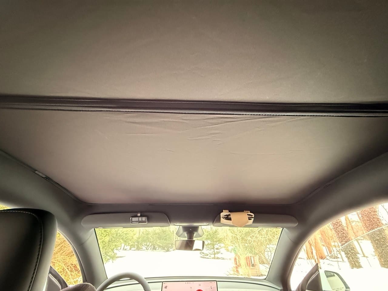 Rear view showing full sunshade coverage across the glass roof