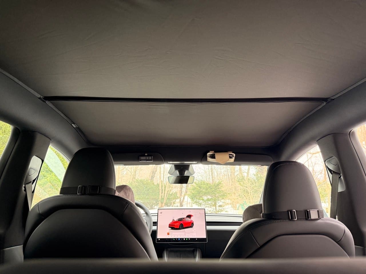 Rear panoramic view with Tesla screen showing red Model Y