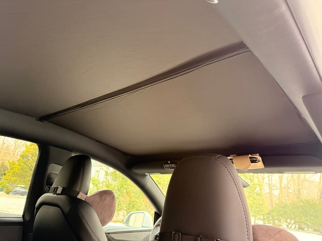 View from rear seat showing headrests and sunshade overhead