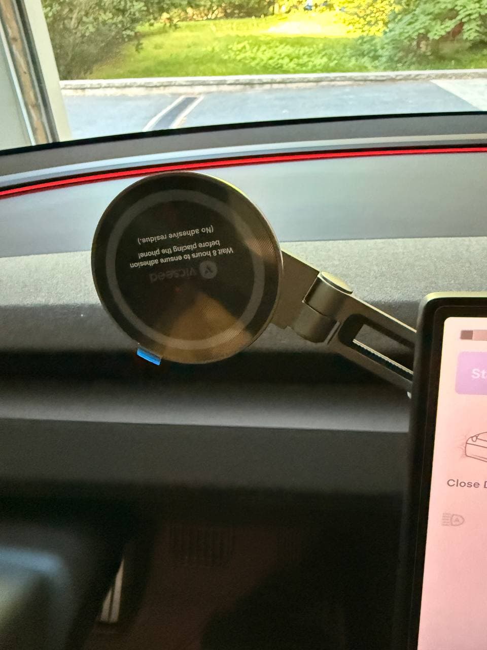 VICSEED phone mount installed behind Tesla screen with magnetic ring extended