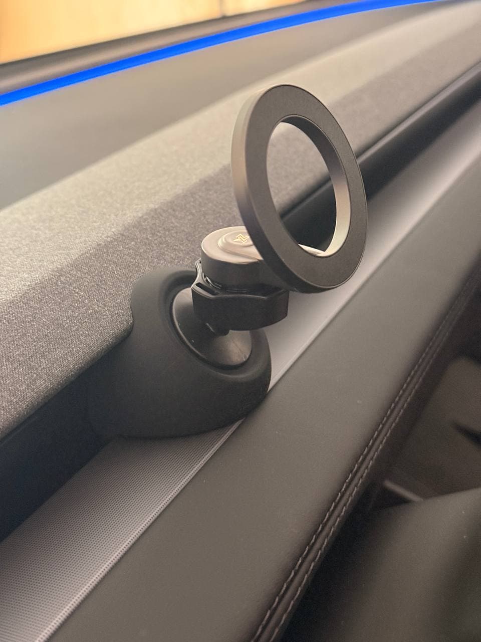 YONZEE phone mount holding a bare iPhone 17 on the driver side of a Tesla Model Y Juniper