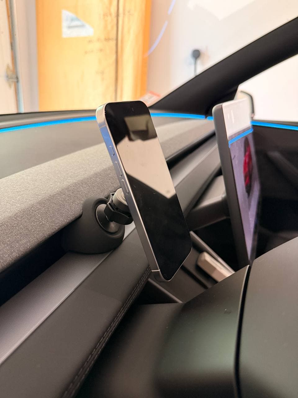 Close-up of YONZEE phone mount on the passenger side of a Tesla Model Y Juniper