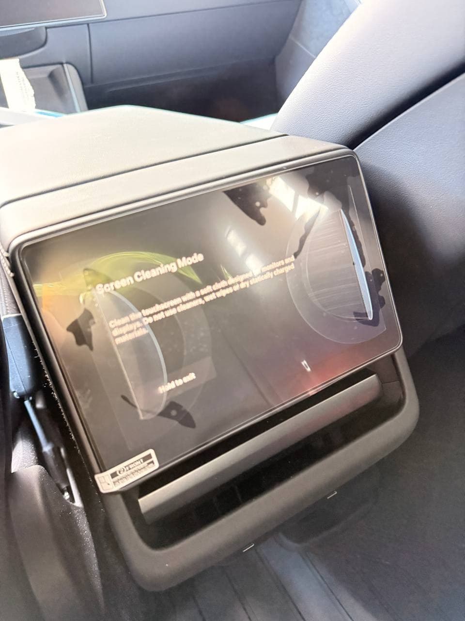 Wigoo rear screen protector being aligned on Tesla Model Y Juniper rear display