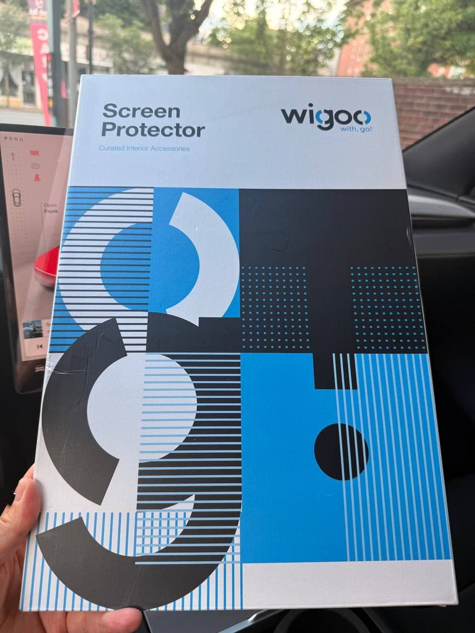 Wigoo screen protector packaging inside a Tesla Model Y Juniper