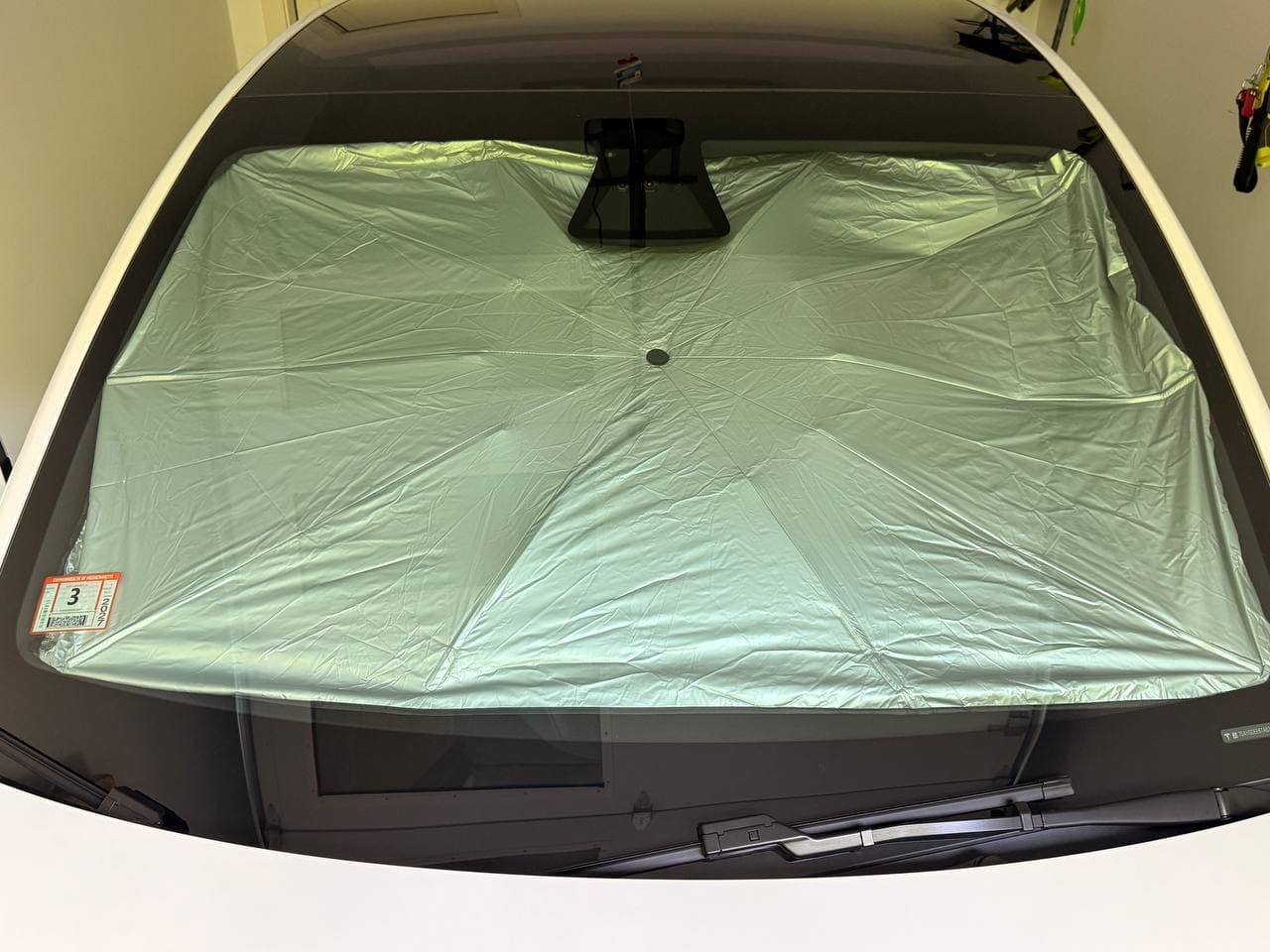 Exterior view of DooGooCoo sunshade blocking Tesla windshield visibility