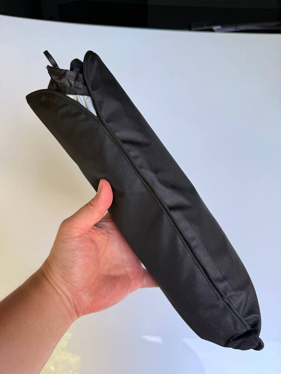 DooGooCoo windshield sunshade storage sleeve held in hand