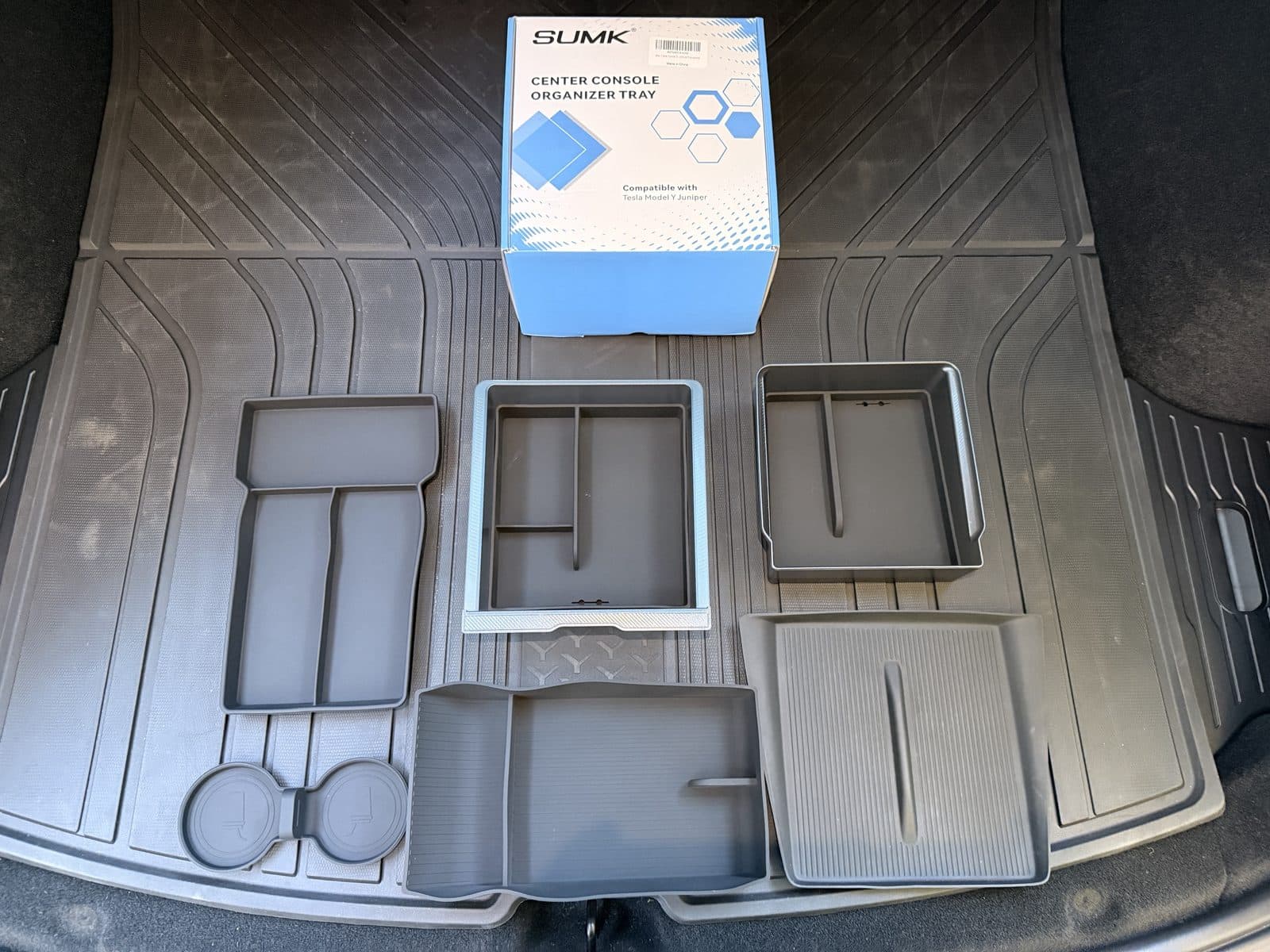 All eight SUMK console organizer pieces laid out: two trays, tray mats, two bottom liners, cup pad and charging pad
