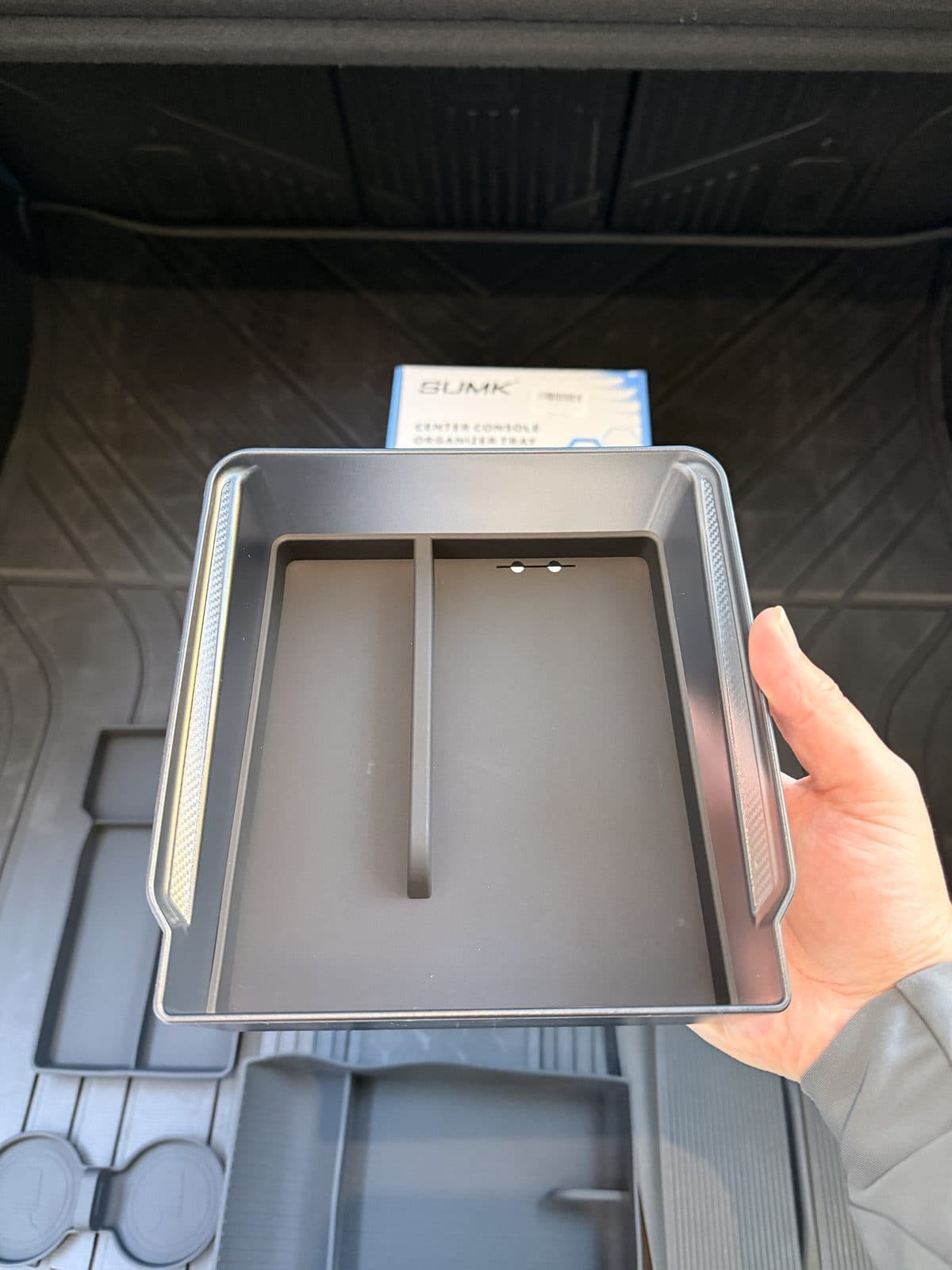 SUMK armrest organizer tray out of the car showing divider and carbon-look edge