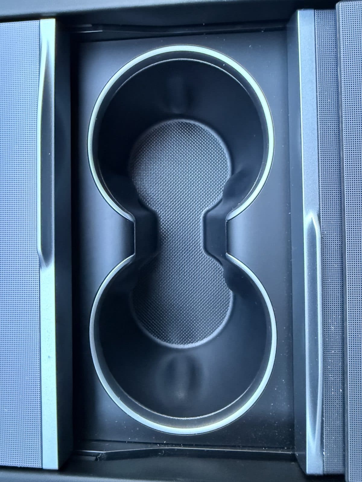 Bare Tesla Model Y Juniper cup holders before installing the SUMK pad