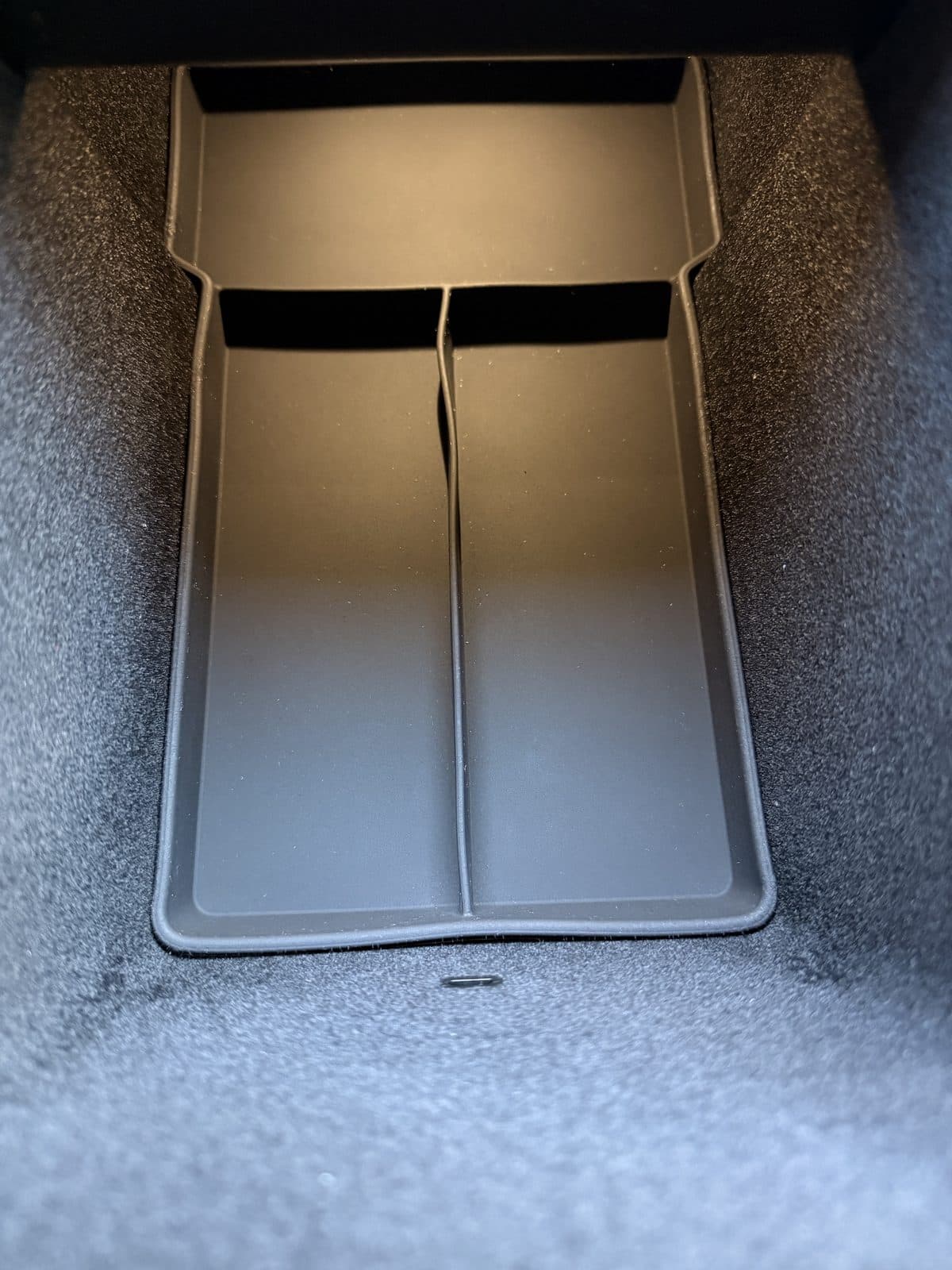 SUMK silicone bottom liner with a raised center divider fitted in a Model Y Juniper console bin