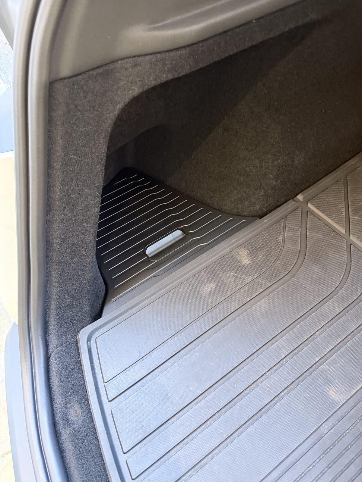Yisuke TPE lid closed over the left trunk side well in a Model Y Juniper