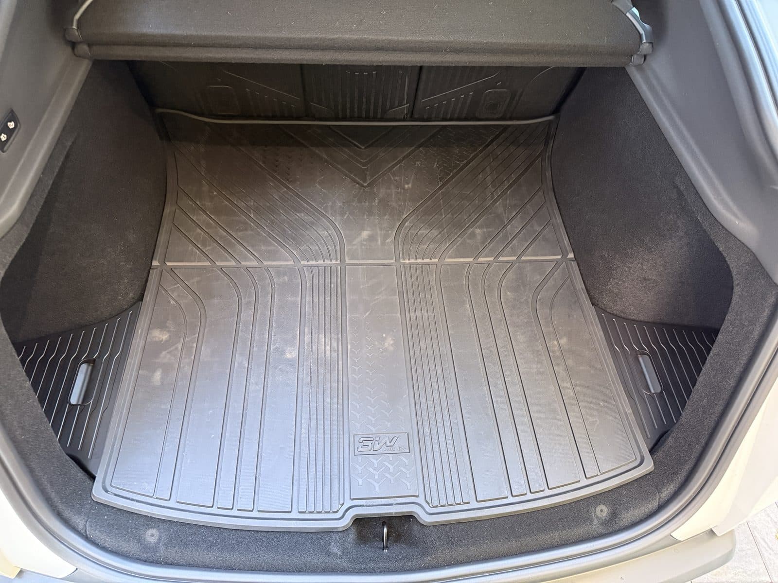 Model Y Juniper trunk with both Yisuke side-well lids closed on either side of a 3W trunk mat